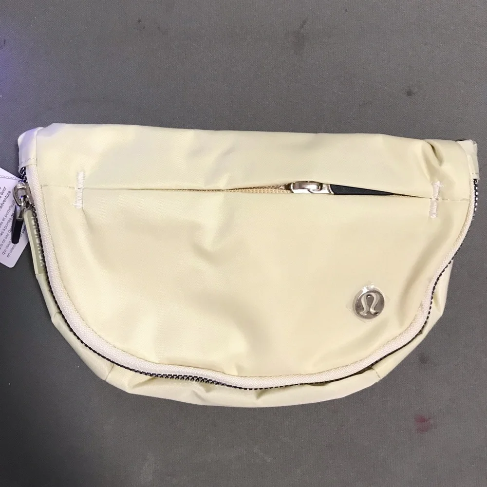 lululemon athletica cream fold-over wristlet with front zip 2L